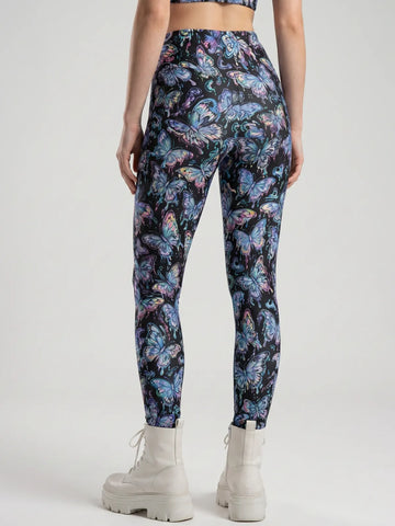 Back view of form-fitting High Waist Festival Pants featuring a neon blue and purple butterfly pattern on a black background.