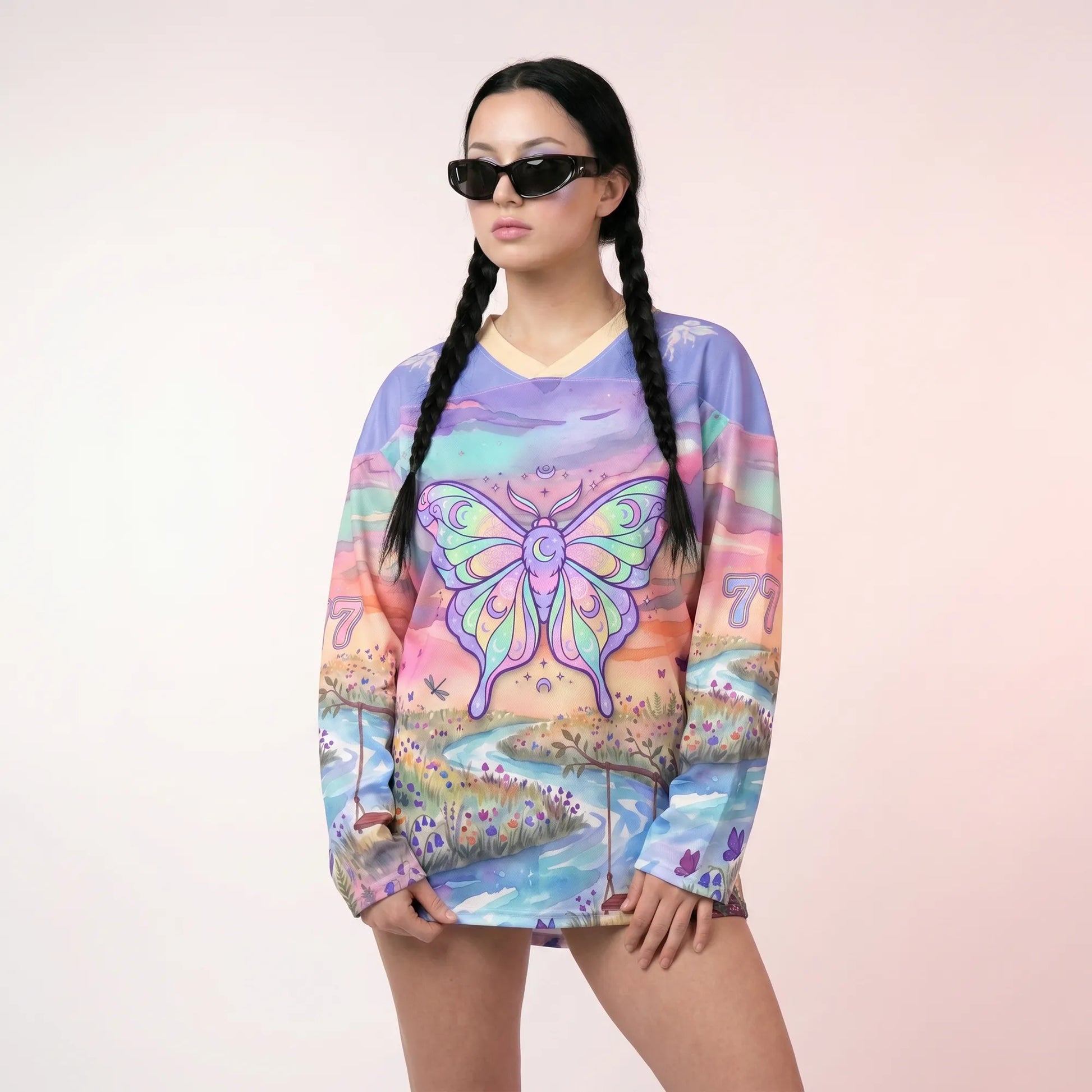 A raver modeling the oversized Pastel Butterfly Rave Hockey Jersey, showcasing the relaxed fit, V-neck collar, and dreamy fairycore landscape graphic