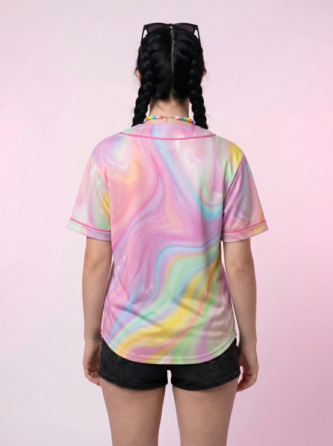 Front view of a pastel mesh rave baseball jersey styled as a summer festival top with black shorts.