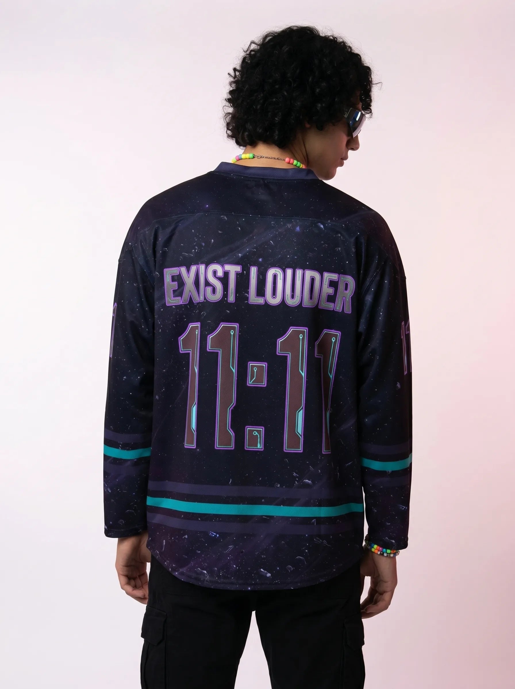 Back view of a model wearing the Rave Hockey Jersey: Sweat-Proof Cosmic EDM Festival Top, showcasing the relaxed oversized fit, drop shoulders, and neon-outlined back graphics.