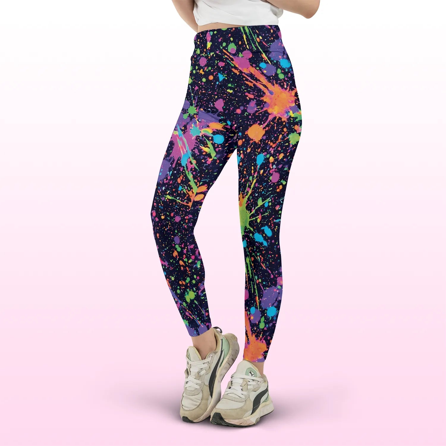Front and side view of neon paint splatter high waist festival pants, showcasing a trippy, colorful pattern for EDM events