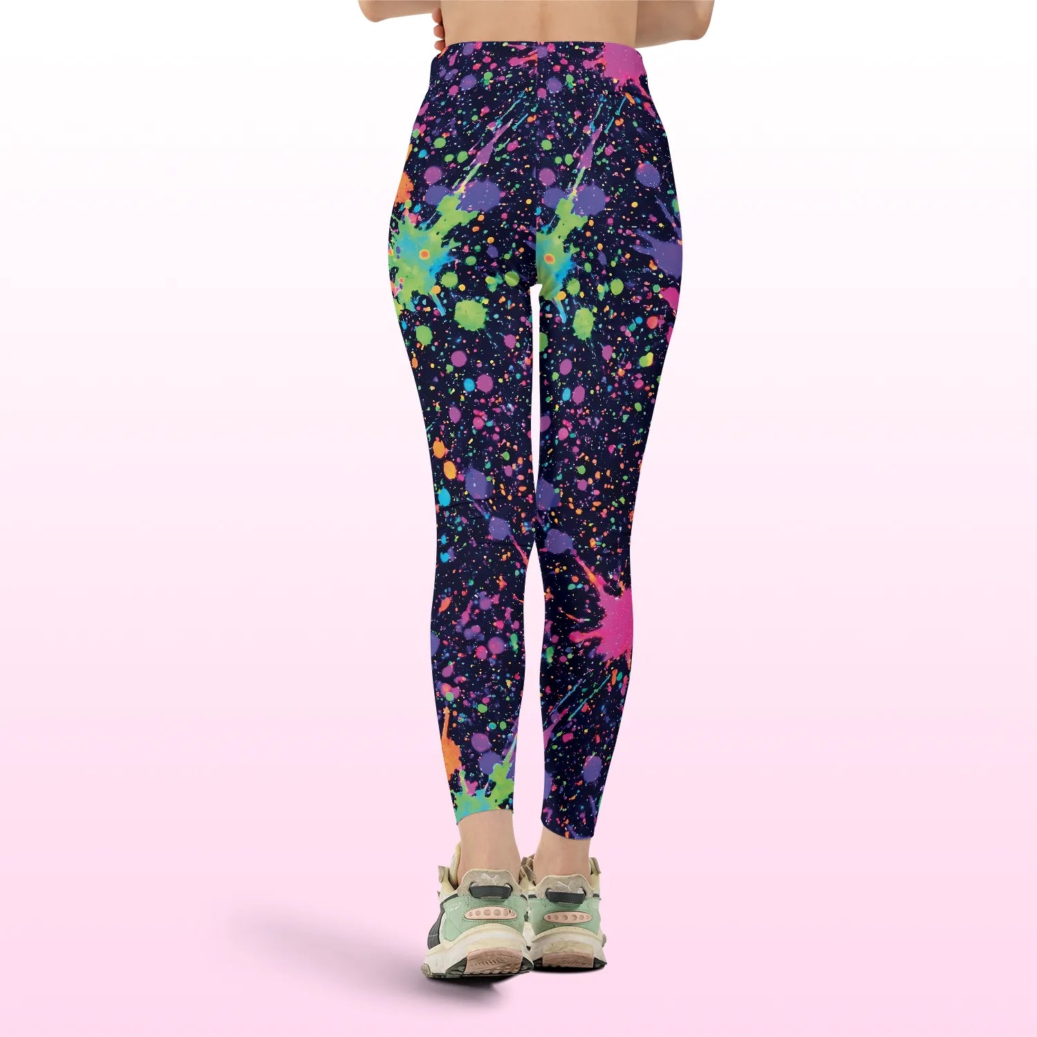 Back view of high-waisted rave leggings featuring a vibrant neon paint splatter design, perfect for festival outfits.