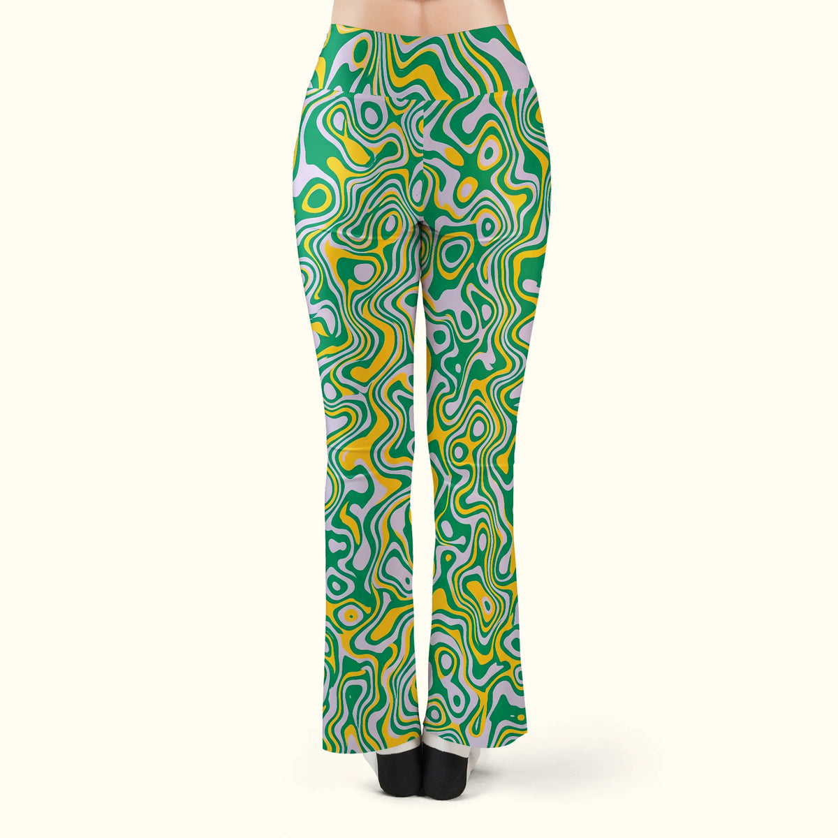 Back view of women's rave leggings featuring a green and yellow trippy swirl pattern and flare bottoms.