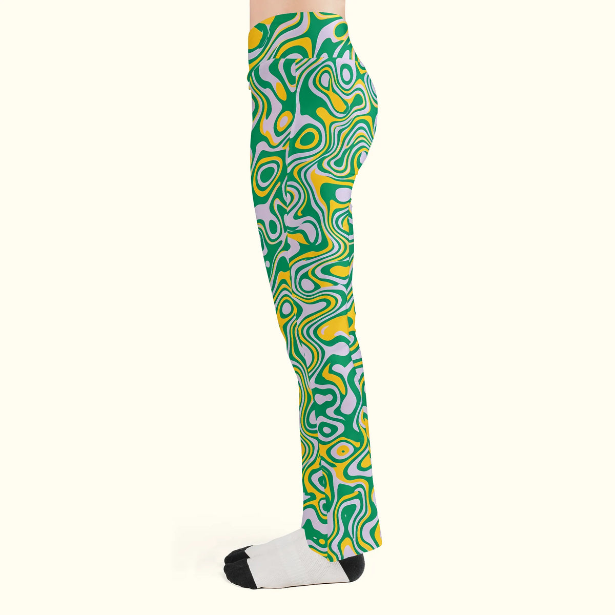 Left side profile of green trippy rave leggings for women, highlighting the snug thigh fit and bell-bottom flare.
