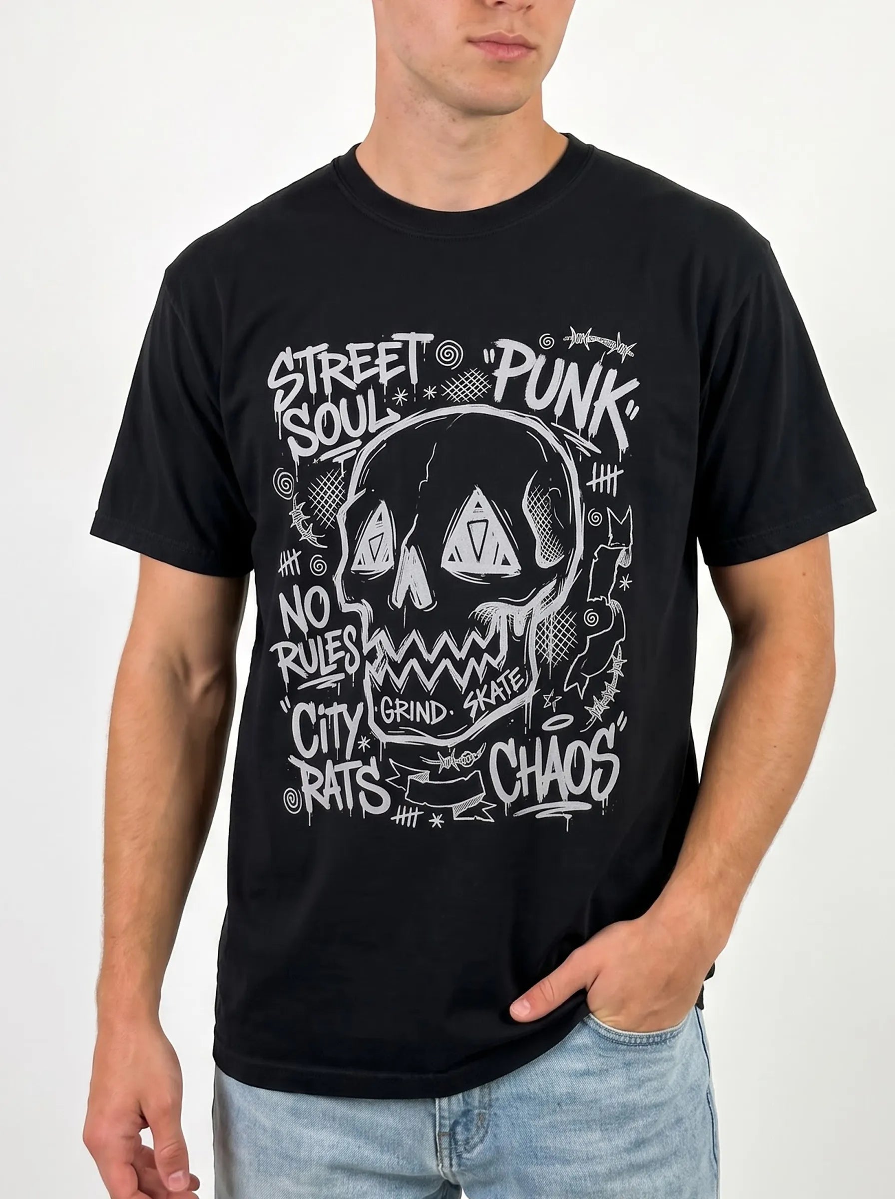 Man wearing a black lived-in cotton punk skull festival top with jeans, showcasing comfortable men's rave outfits with graphic tees.