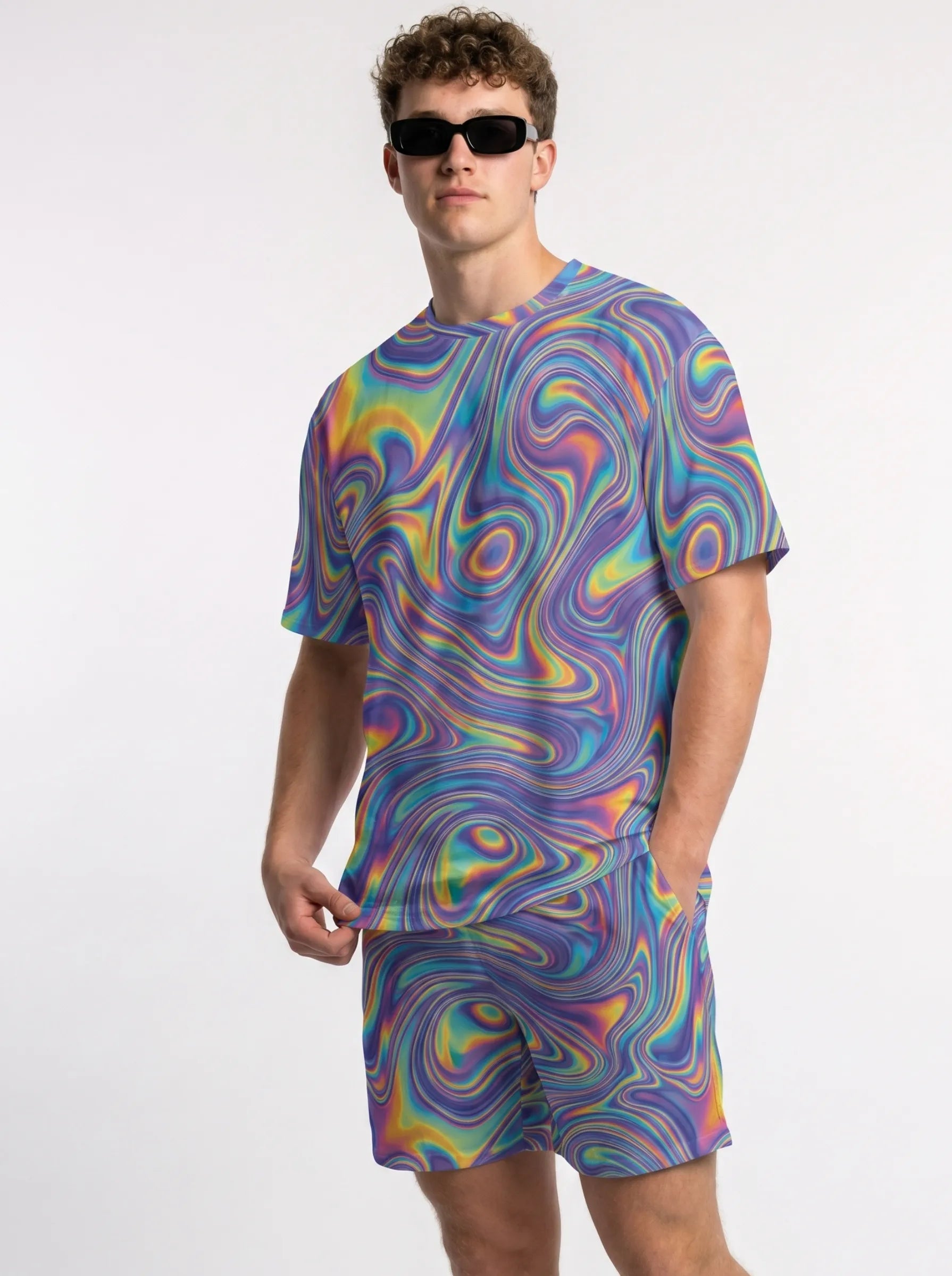Angled shot of a raver posing in the T Shirt Rave Mens Trippy Hologram Festival Top, highlighting the neon purple and green color spectrum.
