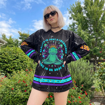 Blonde woman modeling the oversized Trippy 420 Frog Rave Hockey Jersey outdoors, showcasing the front meditating alien frog graphic and breathable festival fit.