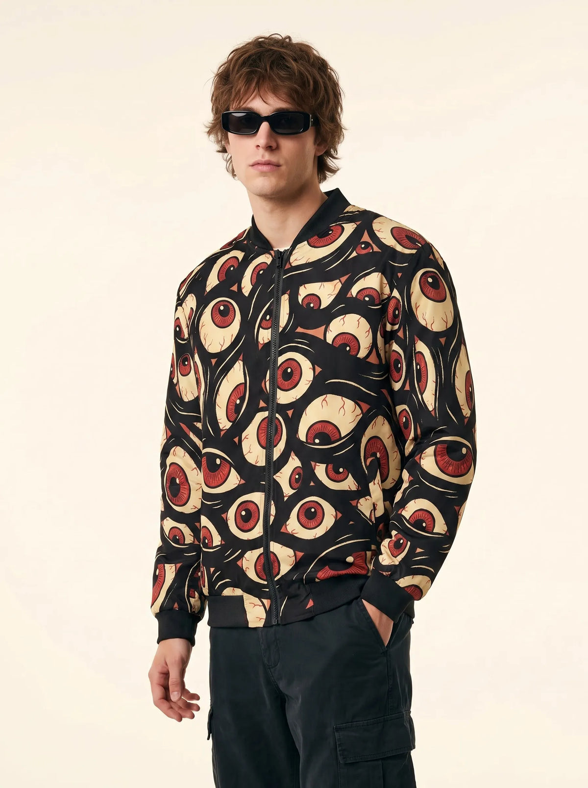Front view of a man modeling the Trippy Halloween Jacket Eye Zip Up Rave Bomber, styled for mens EDM festival clothing.