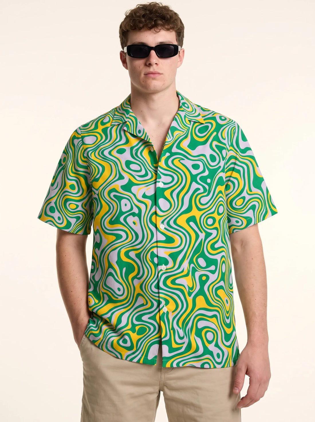 Front view of the green Trippy Hawaiian Shirt featuring a psychedelic yellow and lavender liquid swirl pattern.