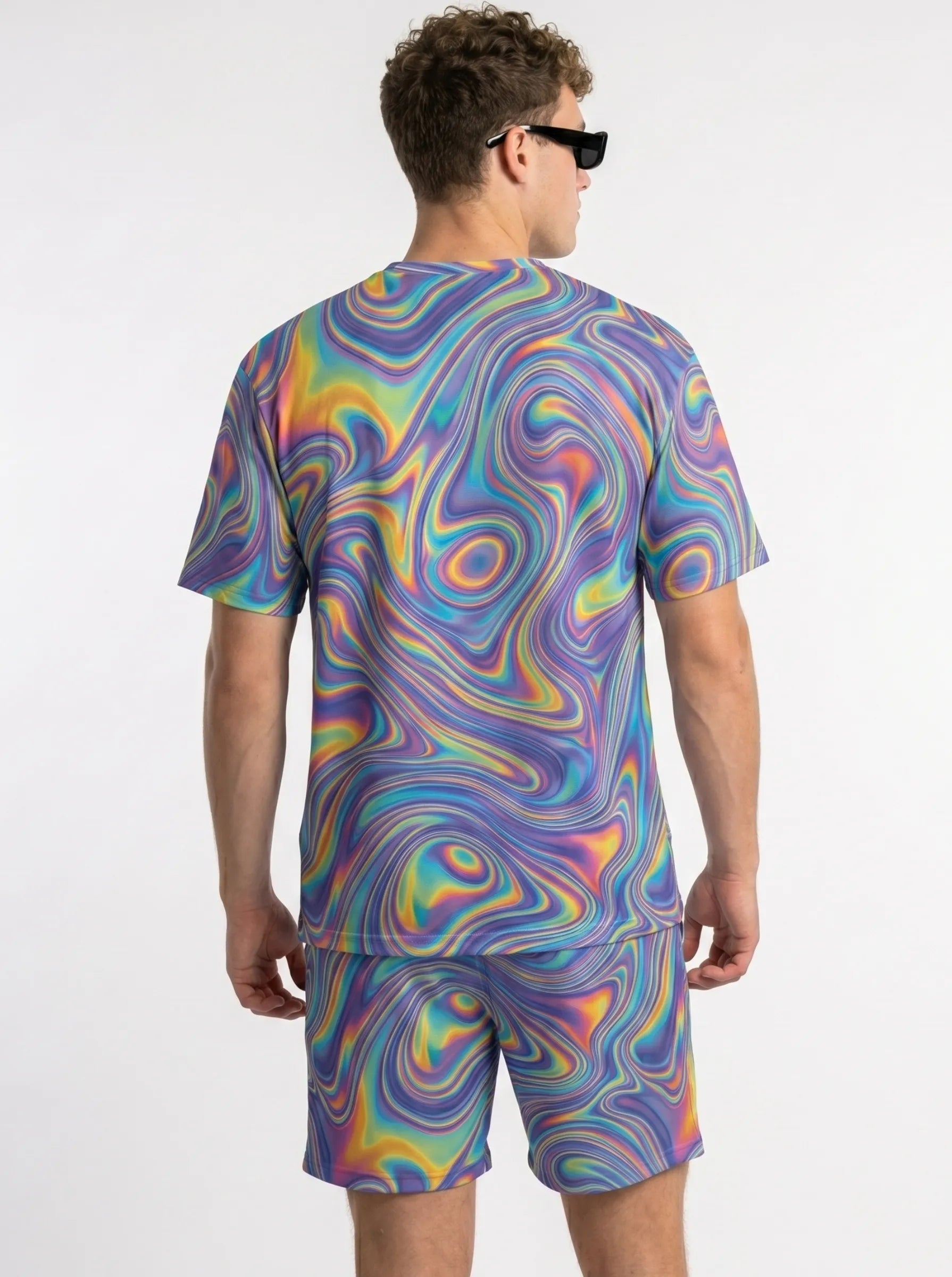 Back view of a male model wearing neon trippy mesh rave shorts and a matching shirt, showcasing the breathable athletic fit and vibrant festival colors