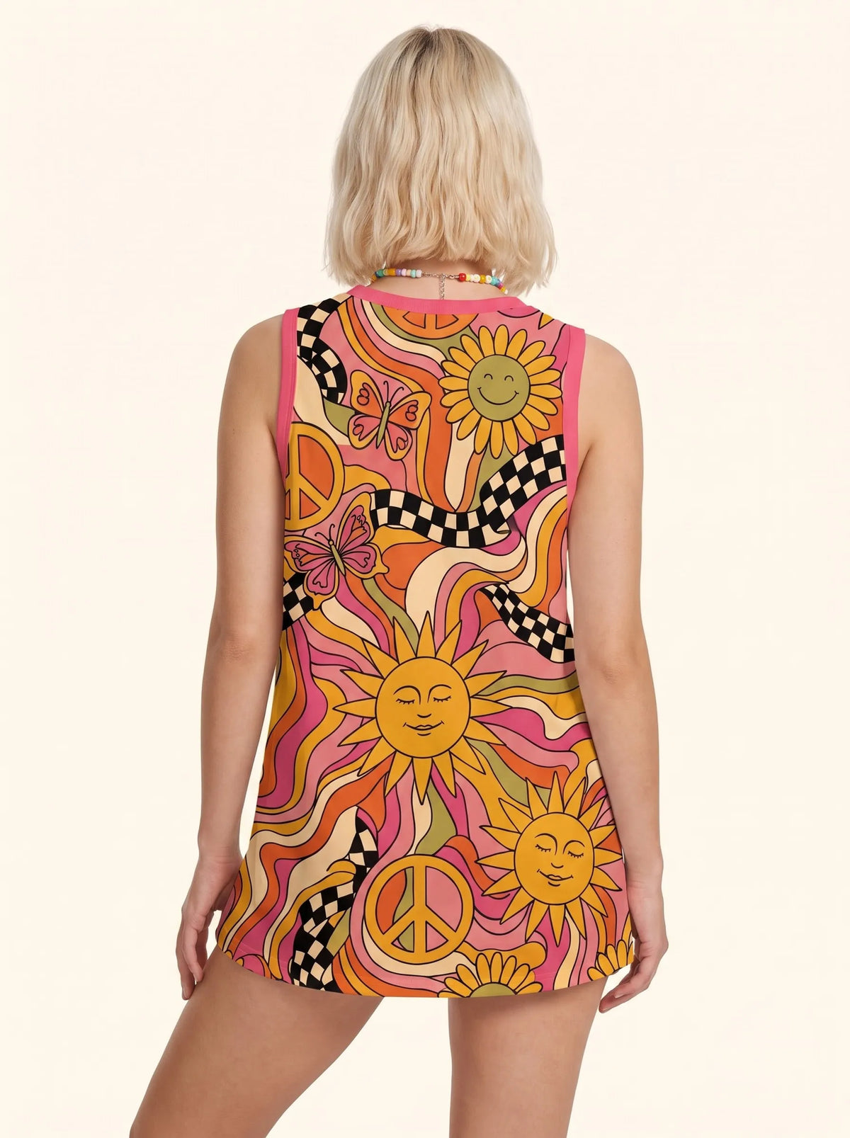 Back view of a model wearing a psychedelic hippie shirt, showcasing the vibrant orange and pink festival outfit design