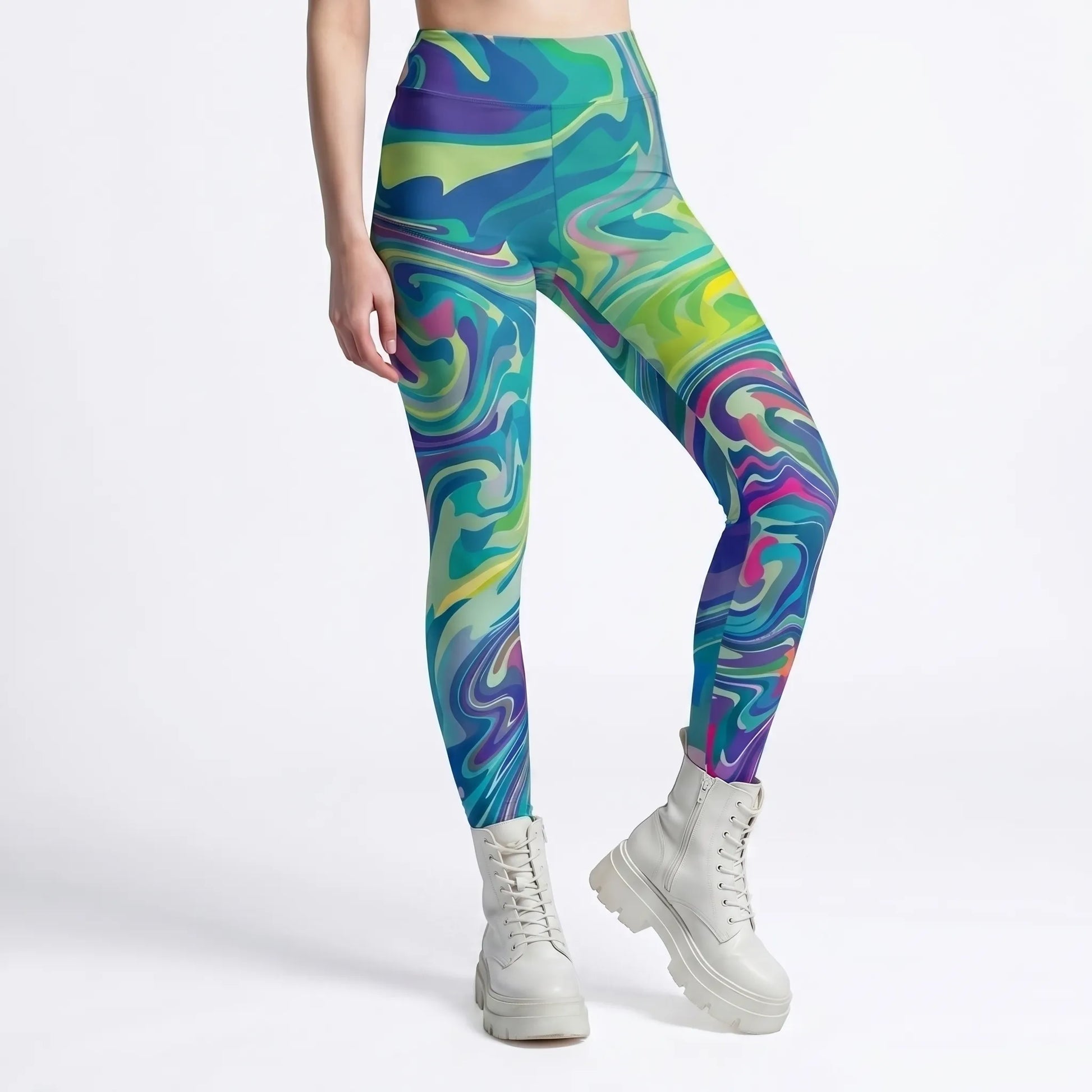 Lower half of a model wearing high-waisted green trippy swirl rave leggings, showcasing the form-fitting, opaque festival bottoms styled with chunky white platform boots.